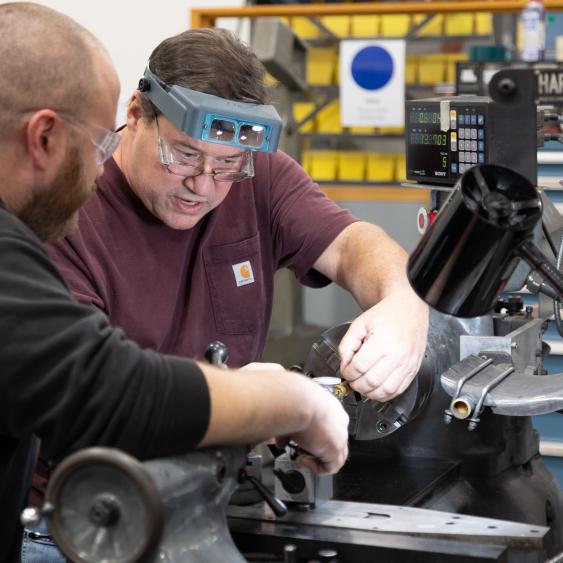 Employees working on machine